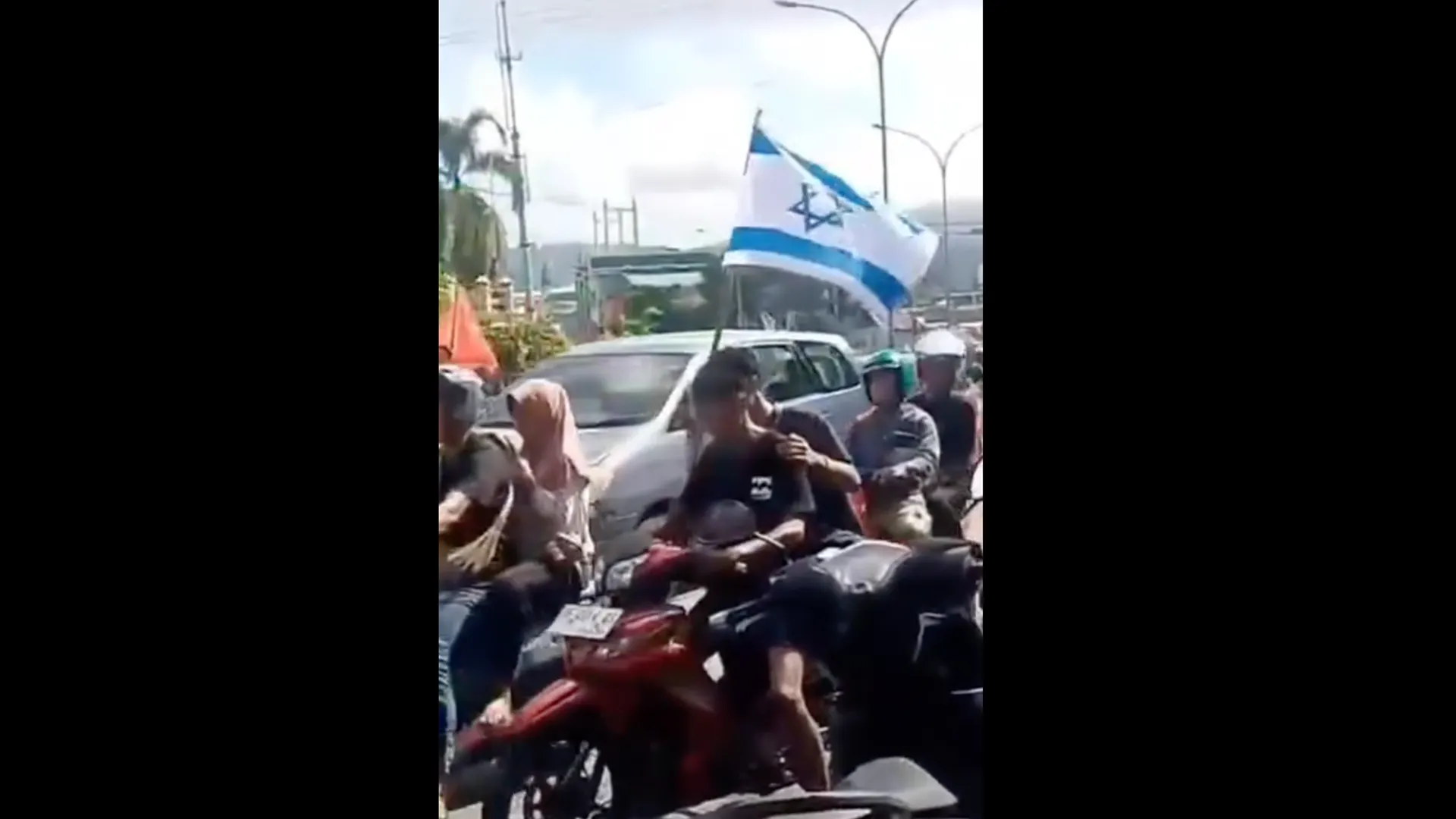Brazil supporters in Indonesia grab Israeli flag off motorcyclist